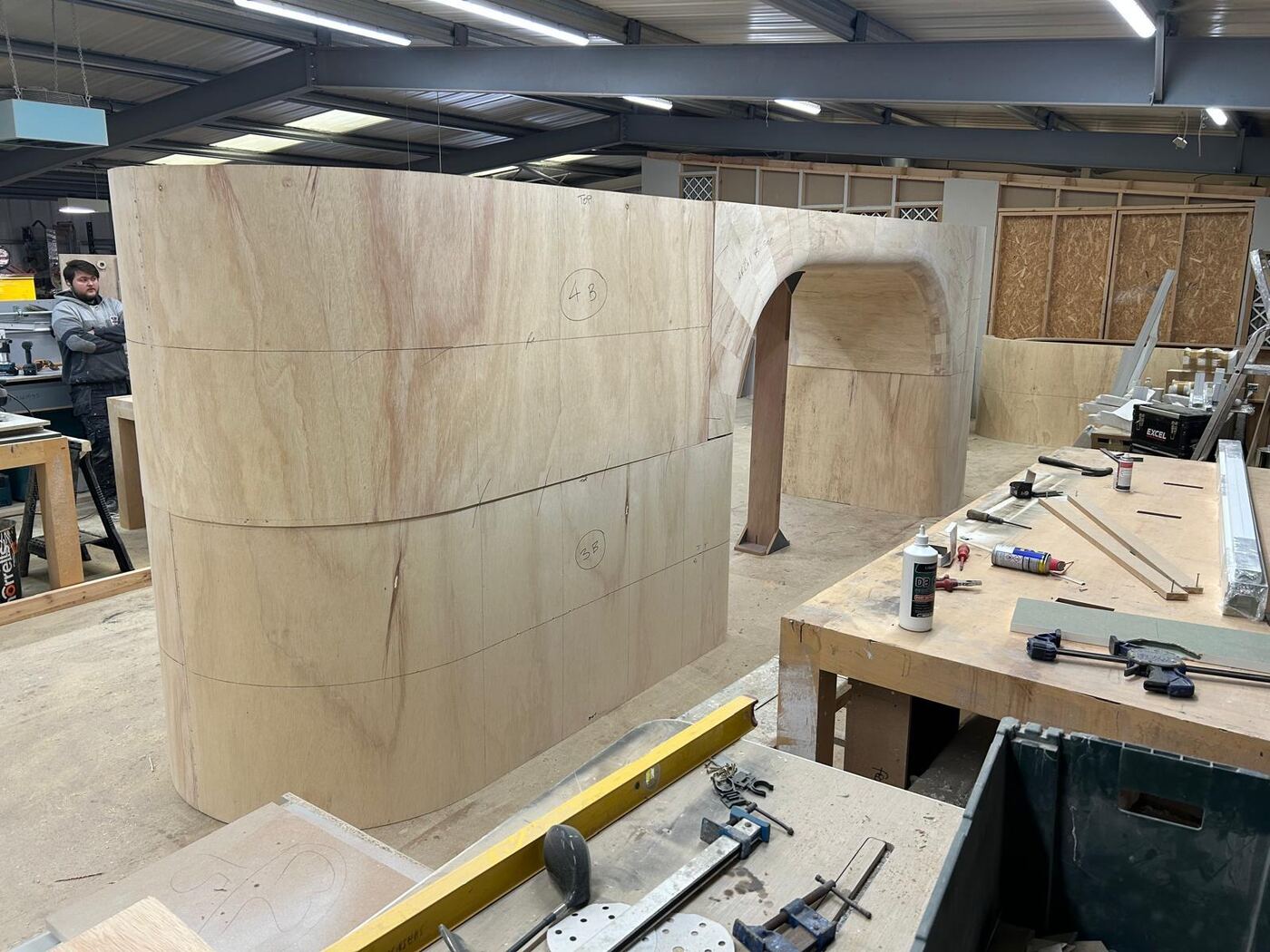 Pop Mart Charing Cross — curved plywood feature wall and archway under construction in our workshop