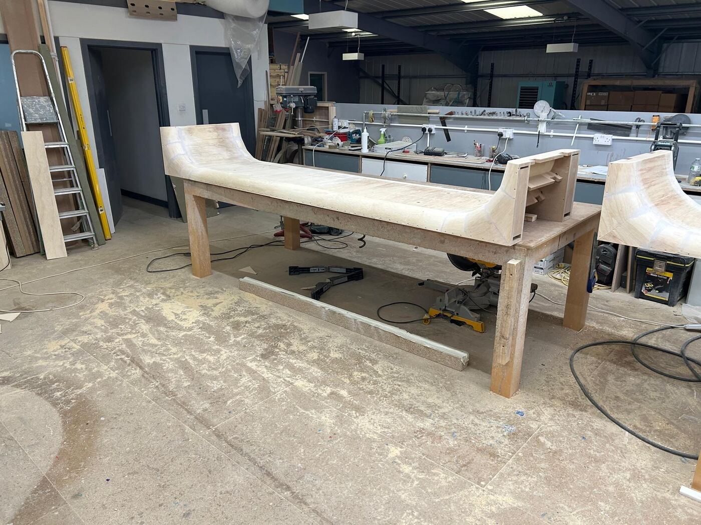 Pop Mart Charing Cross — bespoke curved plinth carcass on the workshop bench