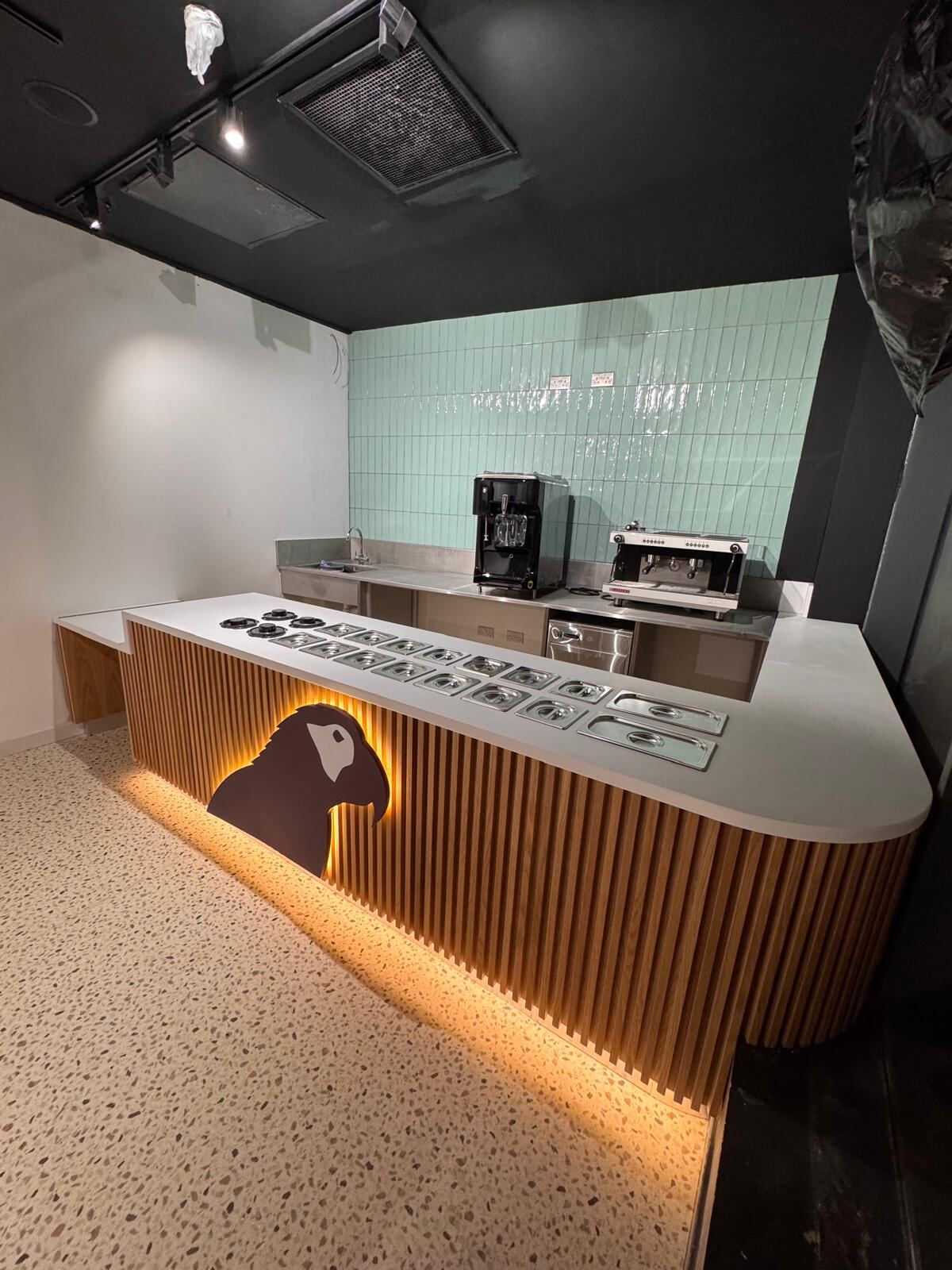 Bespoke joinery — Oakberry counter with branded panel detail and fluted oak ribbing